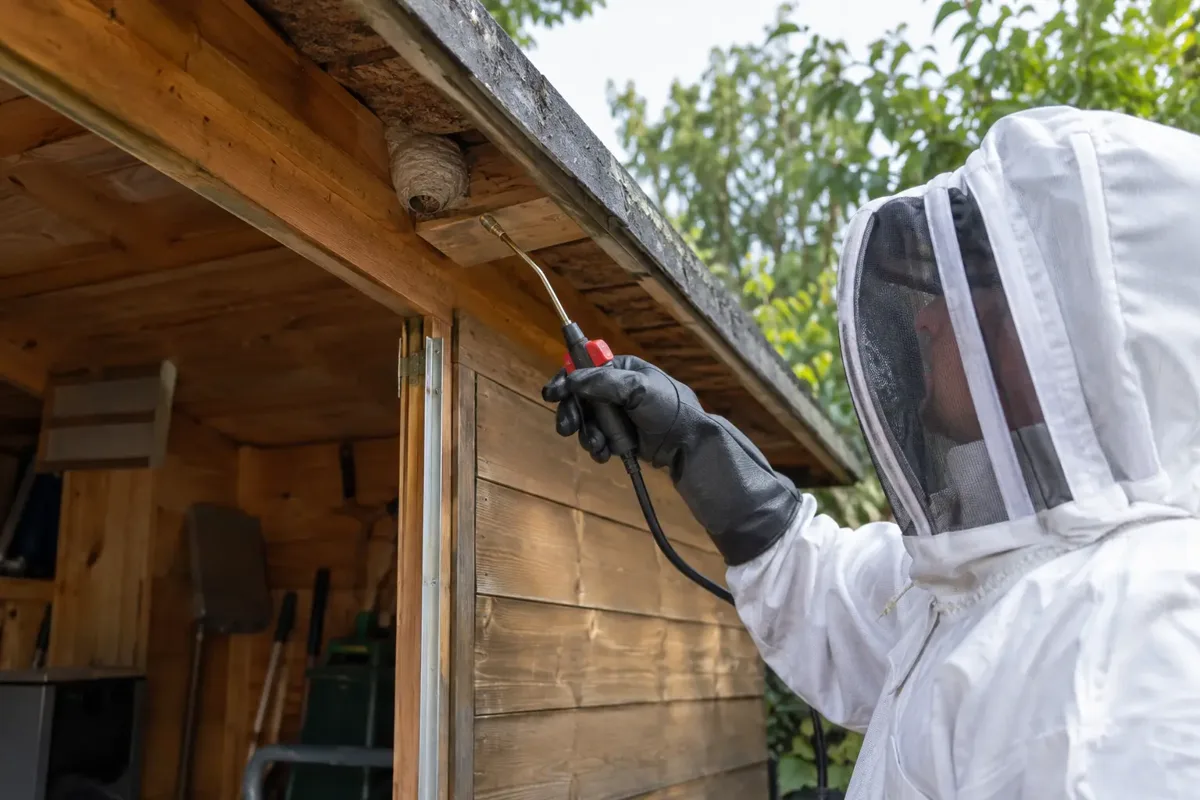 Garage wasp nest treatment by a trained controller