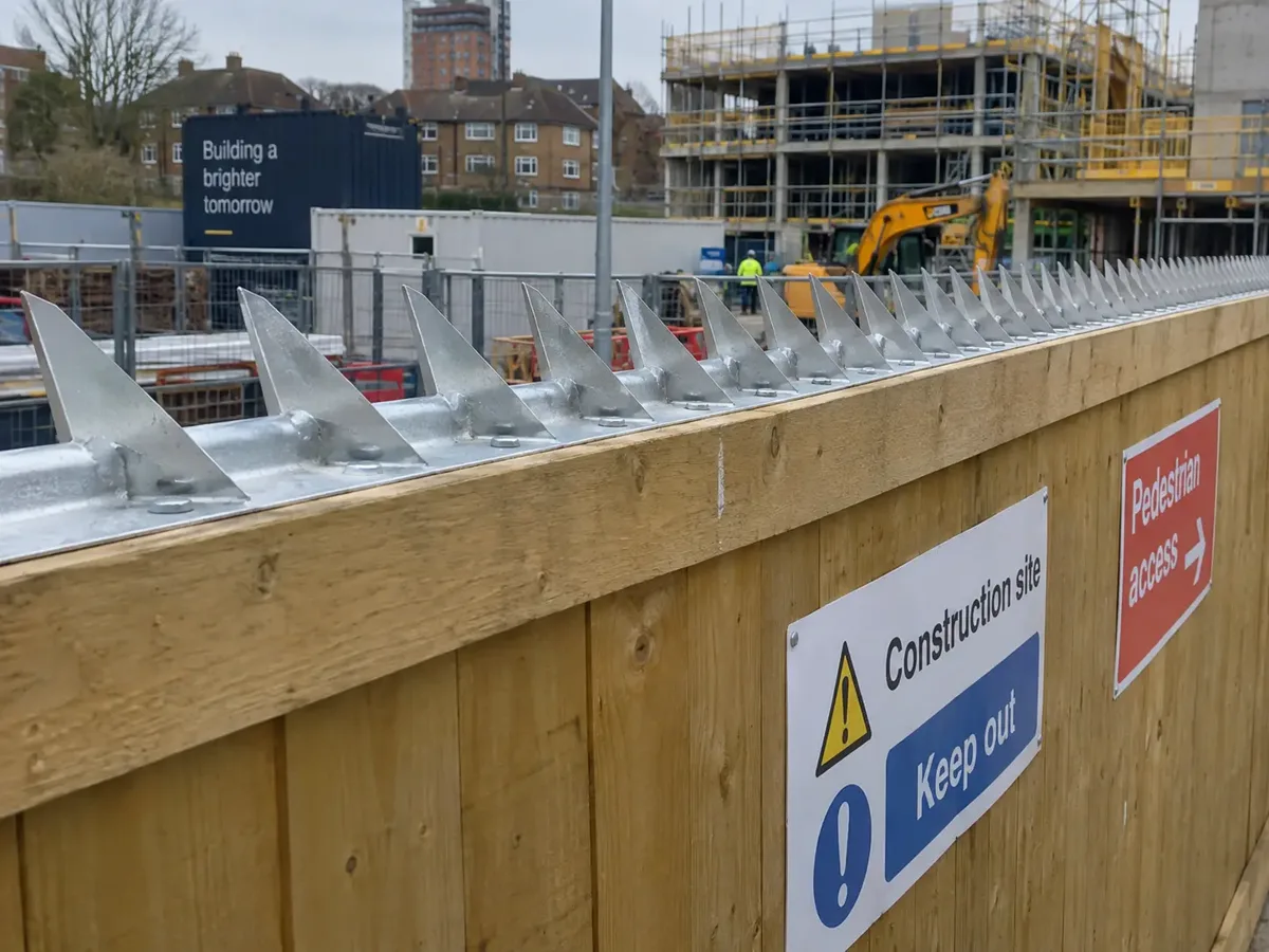 Anti-climb security fittings on timber hoarding
